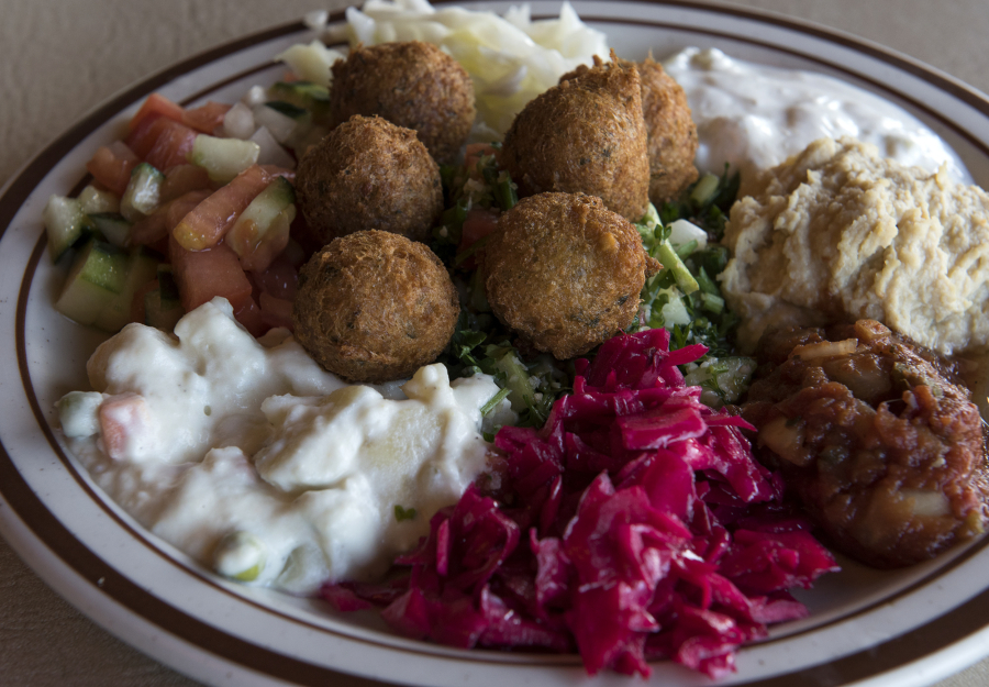 The vegetarian mazza platter with hummus, tabouli, falafel, Mediterranean salad, Turkish salad, tahini, and more is pictured at Jerusalem Cafe.