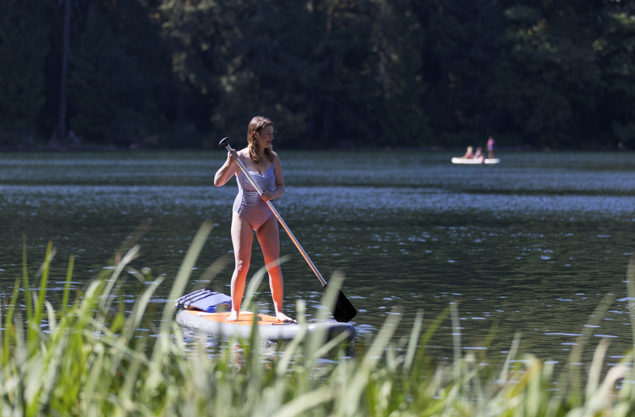 Olivia Van Natta from Bellingham paddles on her board Friday at Battle Ground Lake State Park.