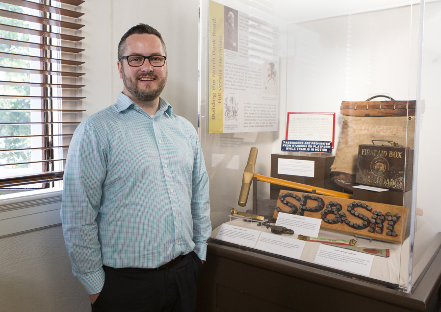 Executive Director Brad Richardson stands in front of an exhibit on the old Spokane, Portland and Seattle Railway in the Clark County Historical Museum.