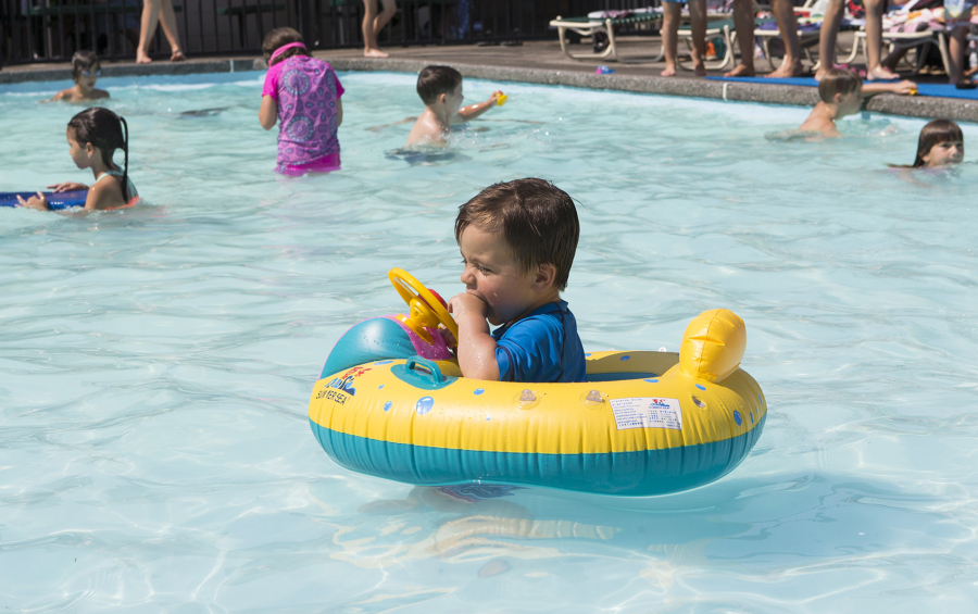 Matteo Gibson, 1, swims around in an inner tube Aug. 28 at the Lake Shore Athletic Club in Vancouver. The National Weather Service says hot temperatures will return to Clark County for the long Labor Day weekend.
