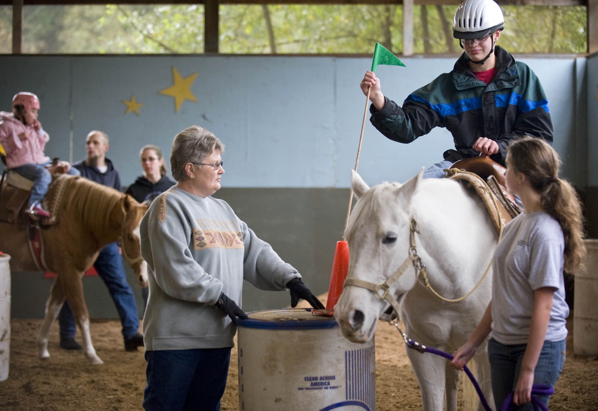 Nancy Elder, center, owner of the Healing Winds Inc., helps lead Tim Smith, 14, through an exercise while on horse back on Saturday November 6, 2009. Elder has been running the center for 20 years, which works mostly with developmentally disabled children. Tim has been visiting the center for 8 years.