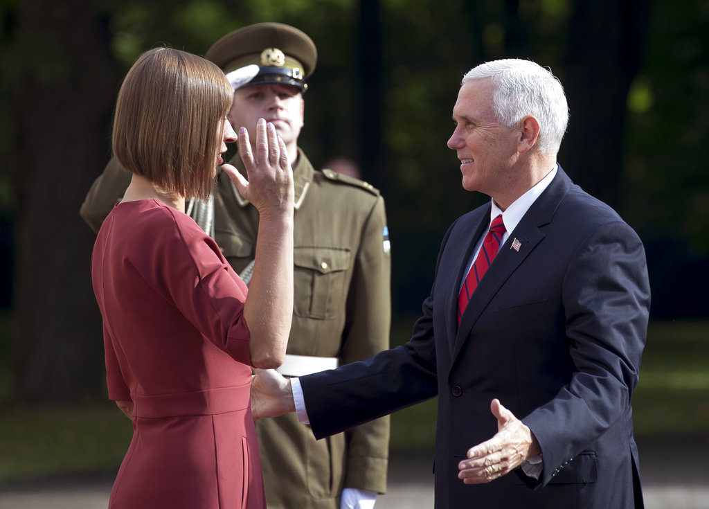 In this July 31, 2017, photo, U.S. Vice President Mike Pence, right, and Estonia's President Kersti Kaljulaid greet each other at the Kadriorg Palace in Tallinn, Estonia. Pence has been a loyal messenger for President Donald Trump. At the same time, he has been carving out his own political identity as the steady understudy to a mercurial president.