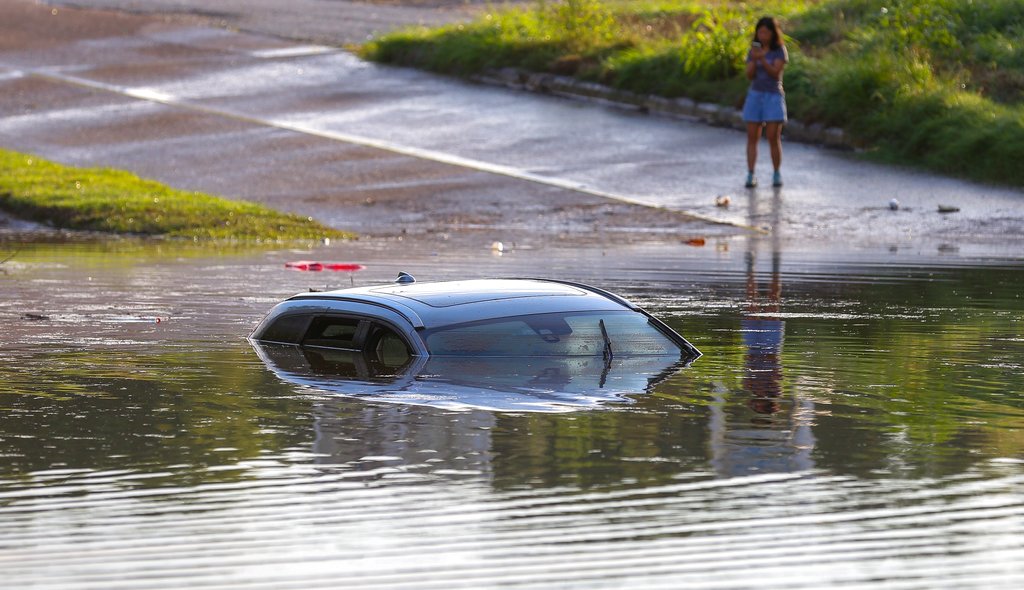 A flooded vehicle is submerged along Studemont Street near Interstate 10, Tuesday, Aug. 8, 2017, in Houston. Torrential rains have brought more flooding to the Houston area as emergency officials urge motorists to stay home until the water recedes. (Godofredo A.