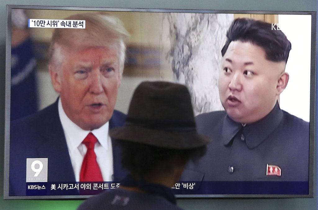 A man watches a television screen showing U.S. President Donald Trump, left, and North Korean leader Kim Jong Un during a news program at the Seoul Train Station in Seoul, South Korea, Thursday, Aug. 10, 2017. North Korea has announced a detailed plan to launch a salvo of ballistic missiles toward the U.S. Pacific territory of Guam, a major military hub and home to U.S. bombers. If carried out, it would be the North's most provocative missile launch to date.
