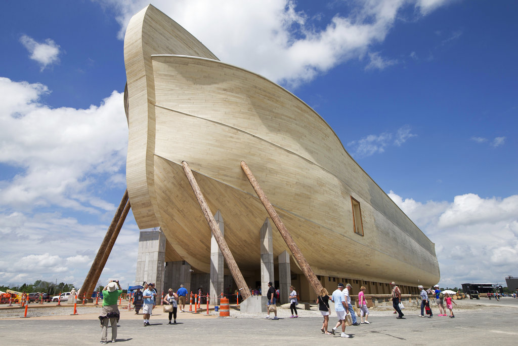 FILE - In this July 5, 2016, file photo, visitors pass outside the front of a replica Noah's Ark at the Ark Encounter theme park during a media preview day, in Williamstown, Ky. The AP reported Aug. 11, 2017, that an article claiming Christian fundamentalist Ken Ham wrote that atheists prayed for his ark attraction to fail is inaccurate.