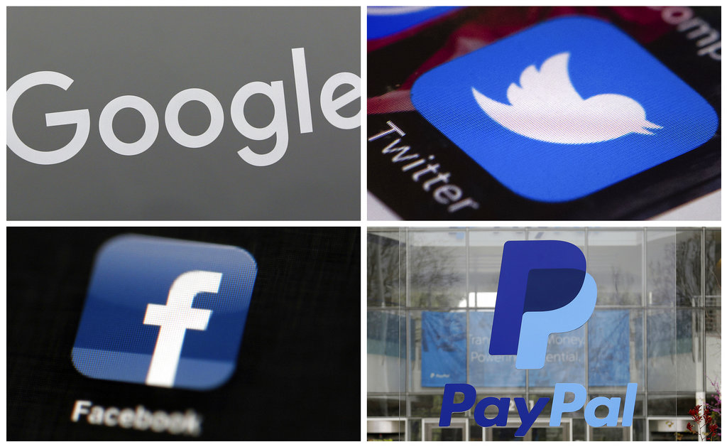 This photo combo of images shows, clockwise, from upper left: a Google sign at a store in Hialeah, Fla., the Twitter app displayed on a smartphone, PayPal headquarters in San Jose, Calif., and the Facebook app displayed on an iPad. It took a violent rally to get tech companies, such as these and others, to do what civil rights groups have been calling for for years: take a firmer stand against accounts used to promote hate and violence.