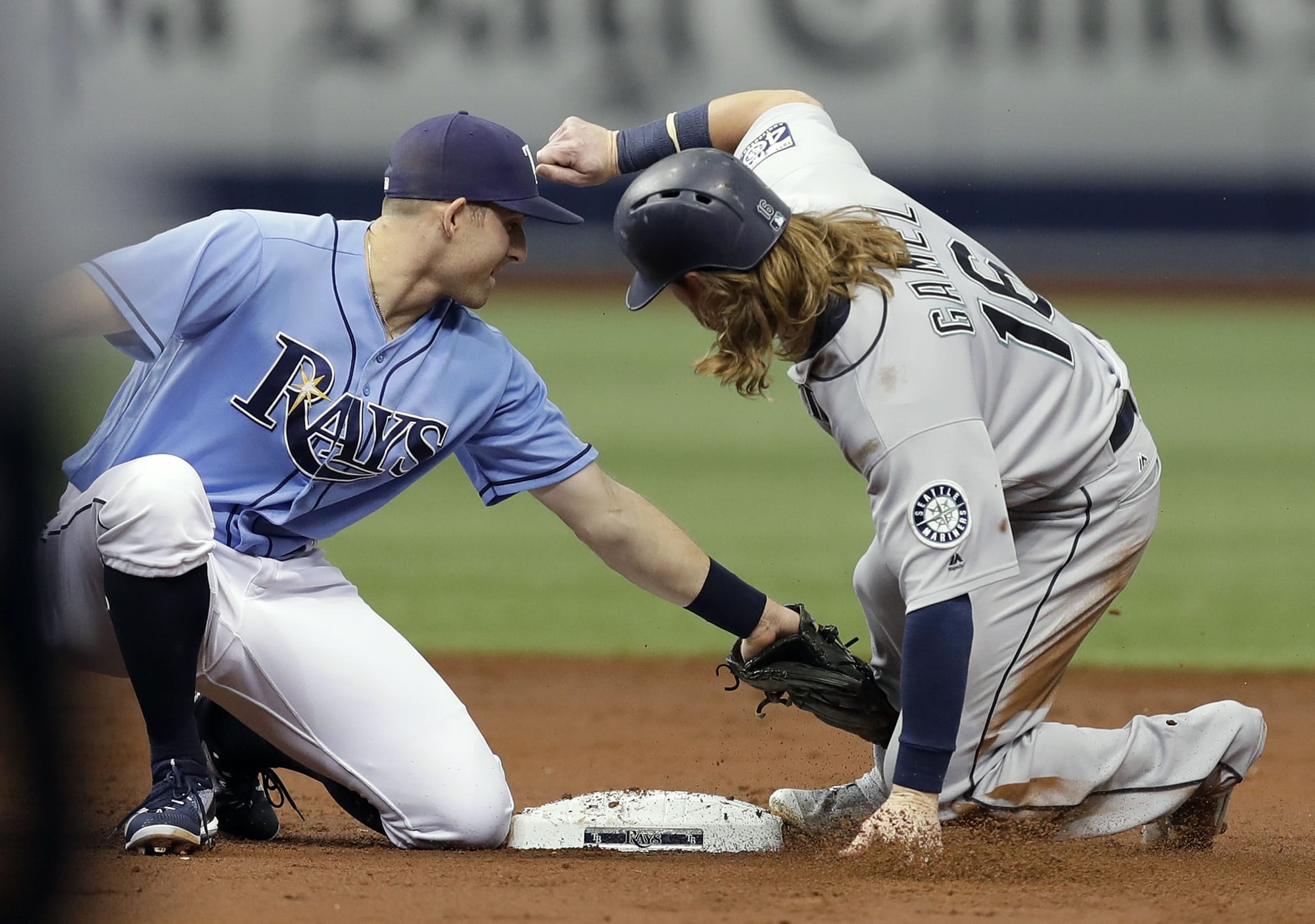 Tampa Bay Rays second baseman Brad Miller, left, tags out Seattle Mariners' Ben Gamel attempting to steal second base during the third inning of a baseball game, Sunday, Aug. 20, 2017, in St. Petersburg, Fla.