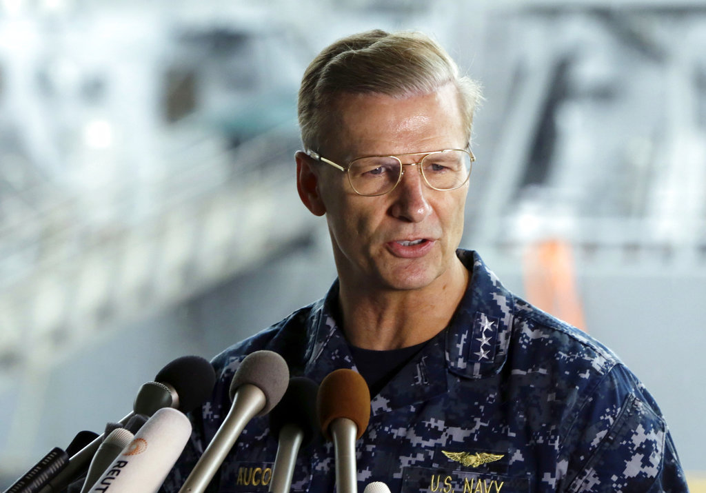 FILE - In this June 18, 2017, file photo, U.S. Navy Vice Adm. Joseph Aucoin, Commander of the U.S. 7th Fleet, speaks during a press conference, with damaged USS Fitzgerald as background at the U.S. Naval base in Yokosuka, southwest of Tokyo. U.S. officials said that Aucoin is to be relieved of duty after series of ship accidents in the Pacific.