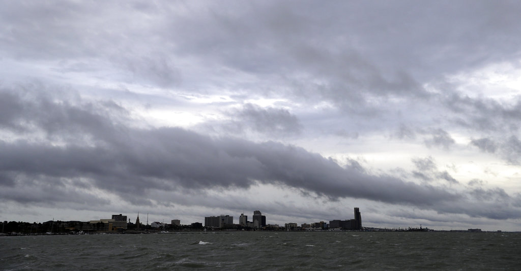 Clouds and rain form over downtown Corpus Christi, Texas, as the outer bands of Hurricane Harvey move closer to shore, Friday, Aug. 25, 2017.  The National Hurricane Center warns that conditions are deteriorating as Hurricane Harvey strengthens and slowly moves toward the Texas coast.