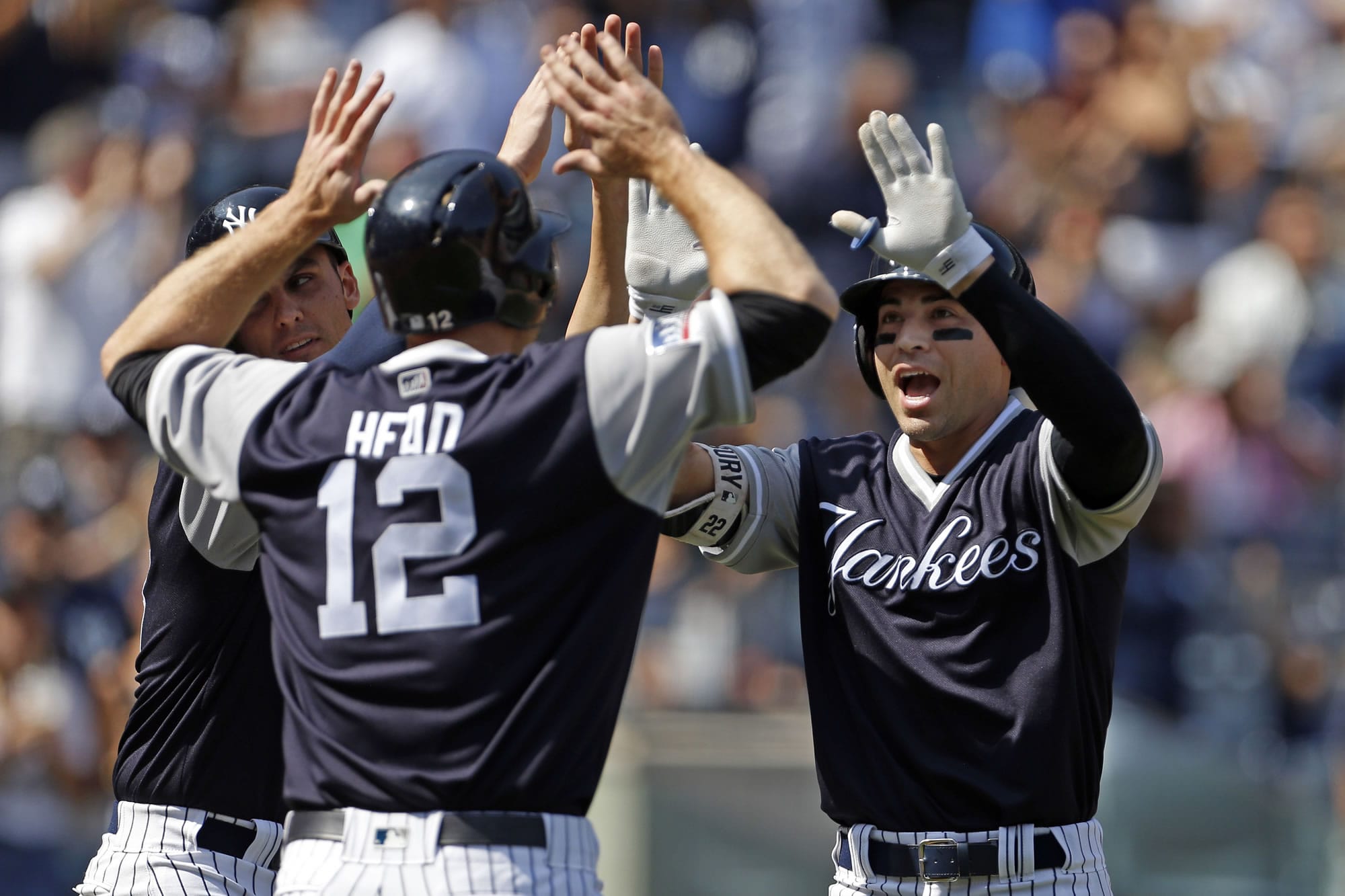 New York Yankees Jacoby Ellsbury, right, celebrates a three-run home run with Chase Headley (12) and Greg Bird during the fourth inning of a baseball game against the Seattle Mariners on Saturday, Aug. 26, 2017, in New York.