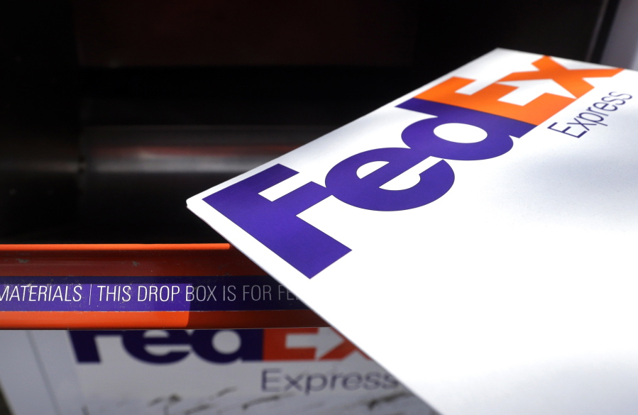 A FedEx envelope is placed into a dropbox in North Andover, Mass.
