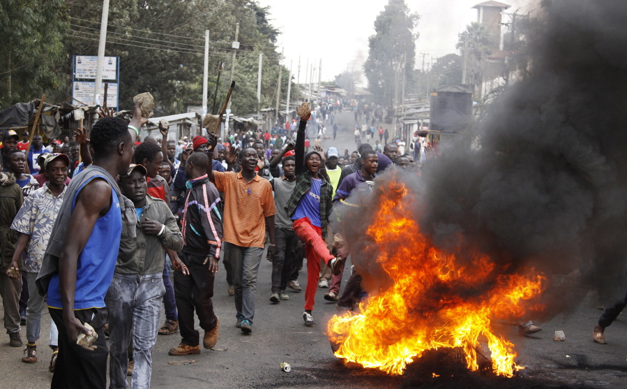 Supporters of opposition leader Raila Odinga make fire barricades to block the road at Kibera slum of Nairobi, Kenya, Saturday, Aug. 12, 2017. Violent demonstrations have erupted in some areas after President Uhuru Kenyatta was declared victorious of the presidential election.