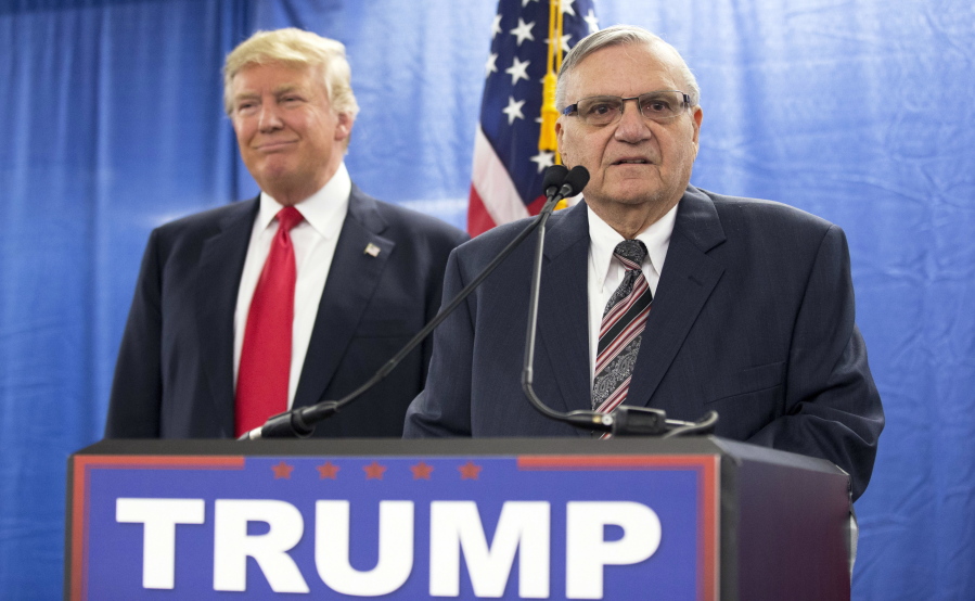 Republican presidential candidate Donald Trump, left, is joined by Maricopa County, Ariz., Sheriff Joe Arpaio during a new conference Jan. 26 in Marshalltown, Iowa. President Donald Trump has pardoned former sheriff Joe Arpaio following his conviction for intentionally disobeying a judge’s order in an immigration case.
