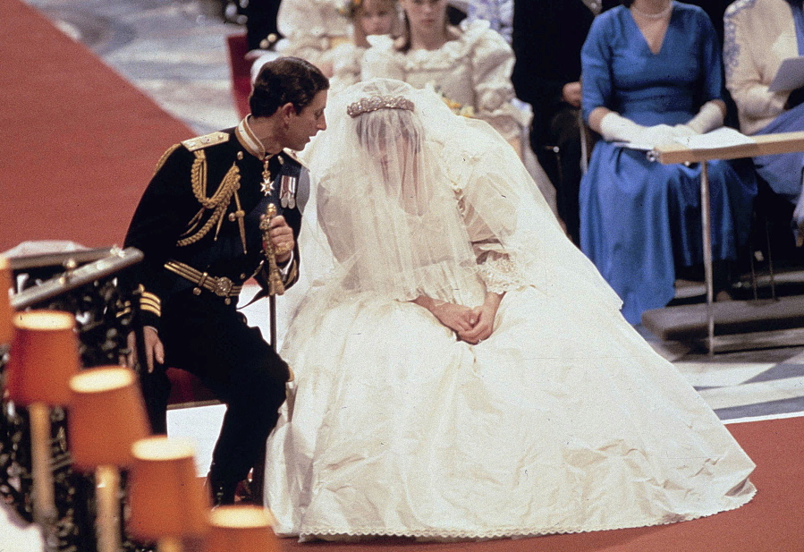 Britain’s Prince Charles as he speaks with his bride Princess Diana, during their wedding ceremony July 29 1981 in St. Paul’s Cathedral, London. Lady Diana Spencer’s fairytale wedding dress in 1981 delighted royal fans with its full silk taffeta gown and 25 foot train designed by David and Elizabeth Emanuel.