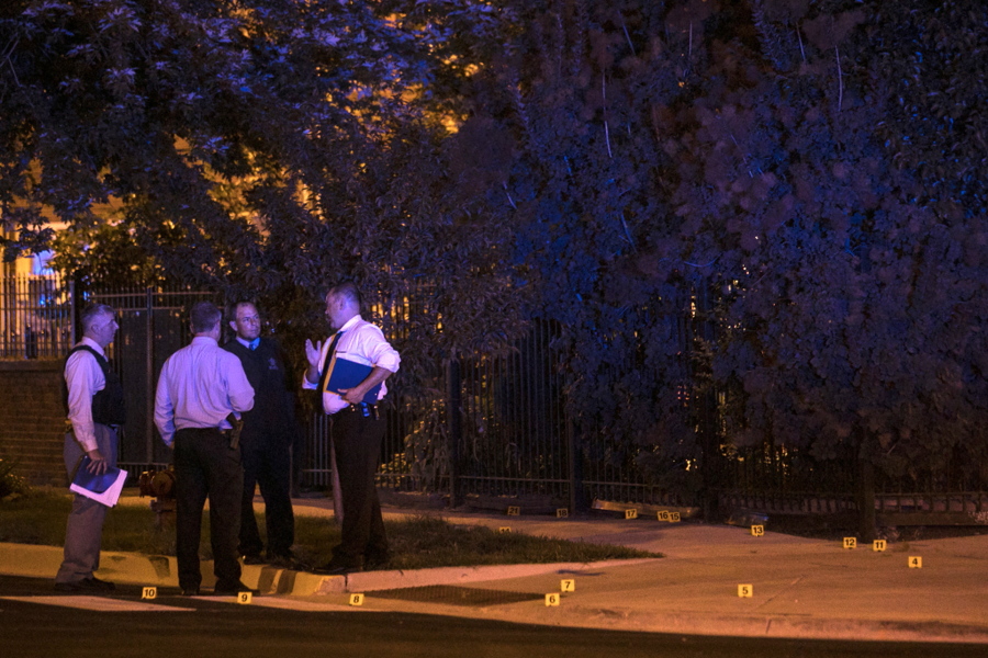 Chicago Police investigate a shooting near East 37th Street and South Michigan Avenue, about two blocks from the Chicago Police Department headquarters. Police say several gunmen opened fire on a group of people standing on a Chicago sidewalk, killing one and wounding six others.
