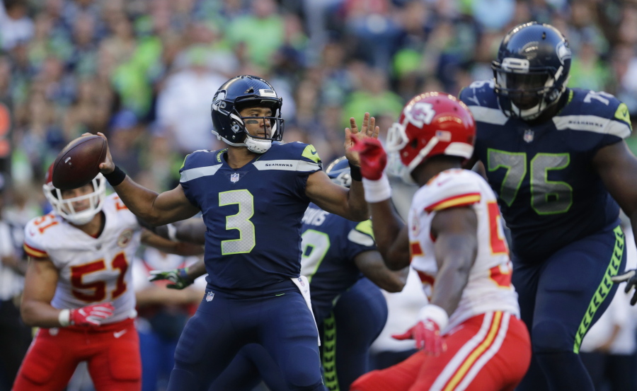 Seattle Seahawks quarterback Russell Wilson (3) looks to pass against the Kansas City Chiefs during the first half of an NFL football preseason game, Friday, Aug. 25, 2017, in Seattle.