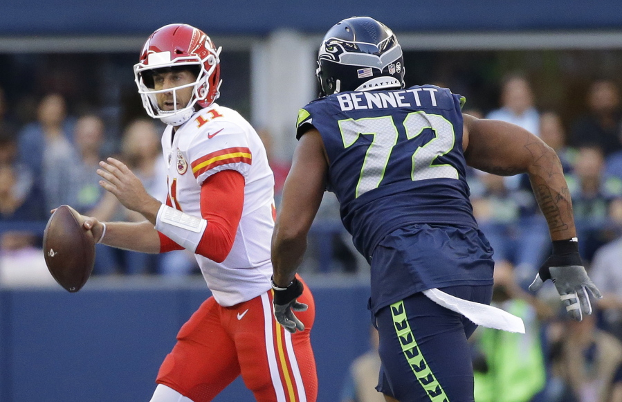 Seattle Seahawks defensive end Michael Bennett (72) pressures Kansas City Chiefs quarterback Alex Smith during the first half of an NFL football preseason game, Friday, Aug. 25, 2017, in Seattle.