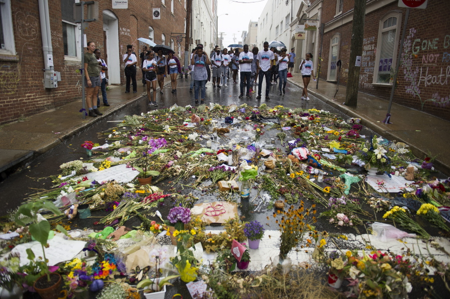 Howard University students visit the site Friday in Charlottesville, Va., where Heather Heyer was killed when a driver rammed a car into a crowd of demonstrators.