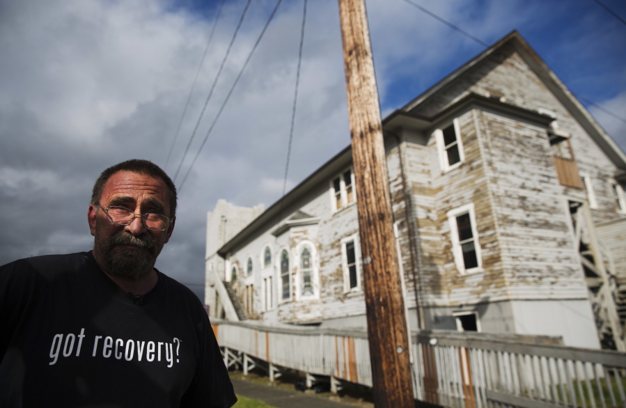 Robert LaCount, a recovering addict, stands outside an old church he is fixing up as a community center in Hoquiam.