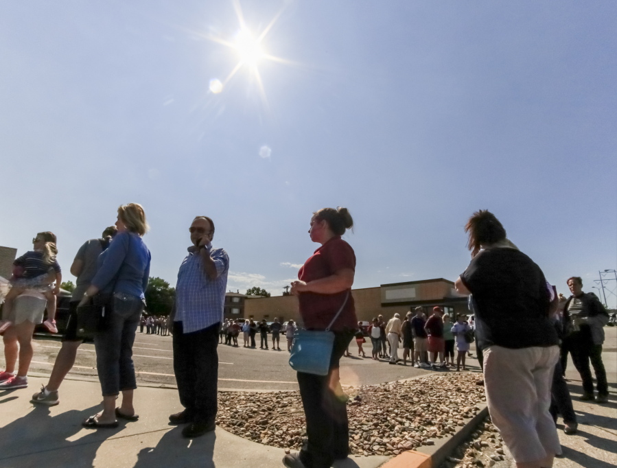 A long line forms Friday outside an arts and crafts store in Omaha, Neb., where a new shipment of eclipse glasses is about to be offered for sale. Officials in states in the path of Monday’s solar eclipse are planning in hopes of avoiding the same kind of gridlock with traffic.