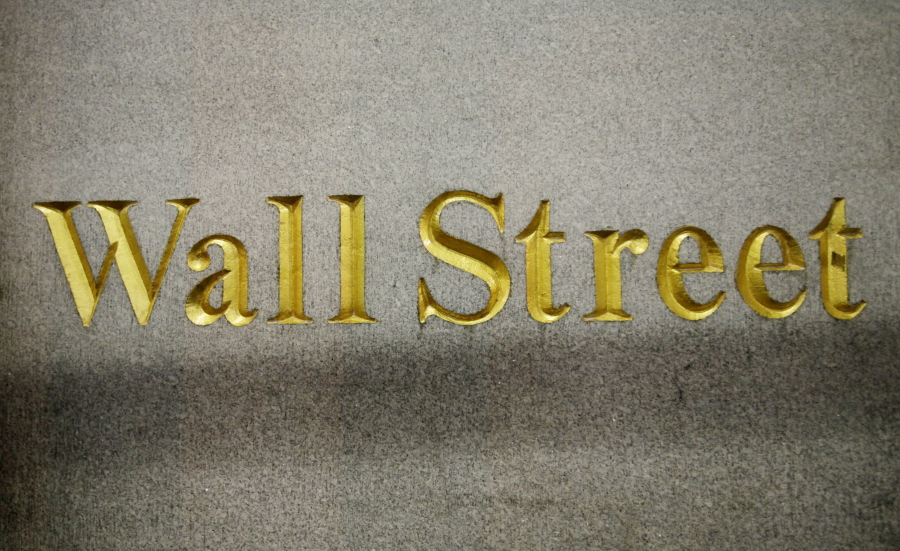 FILE - In this Oct. 8, 2014, file photo, a Wall Street address is carved in the side of a building in New York. Stocks are opening modestly higher on Wall Street, Friday, Aug. 11, 2017, led by gains in technology companies and banks.