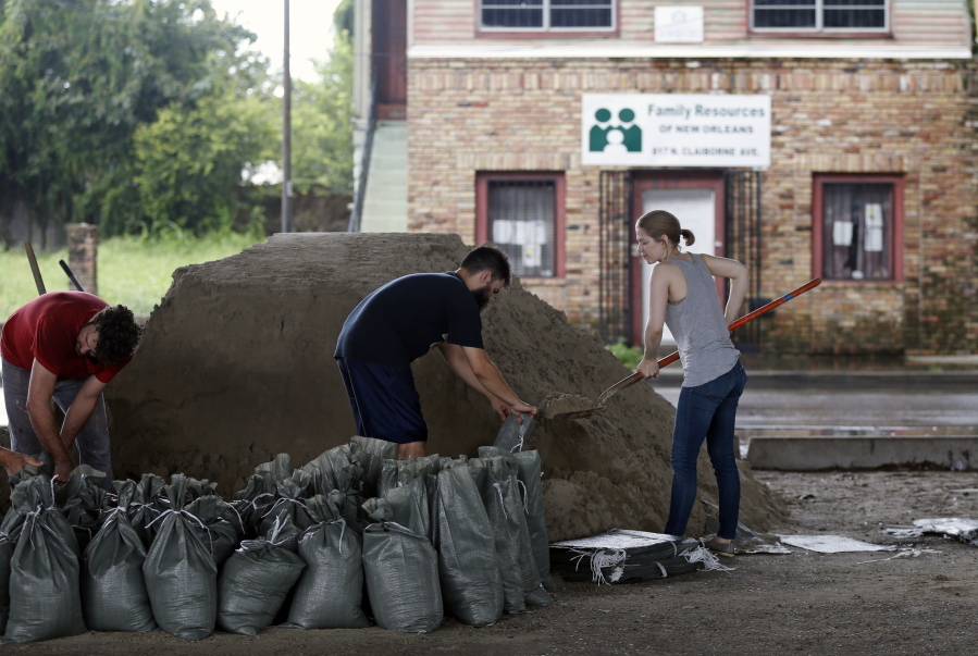Andrea Dube, right, and John Flemming fill sandbags Friday in New Orleans.