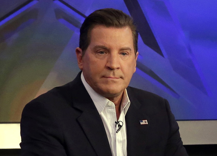 Co-host Eric Bolling appears on “The Five” television program, on the Fox News Channel, in New York. Bolling is suing the reporter who broke the story that he allegedly sent lewd text messages to colleagues. Bolling filed a $50 million defamation lawsuit Wednesday against Yashar Ali, a Huffington Post contributing writer.