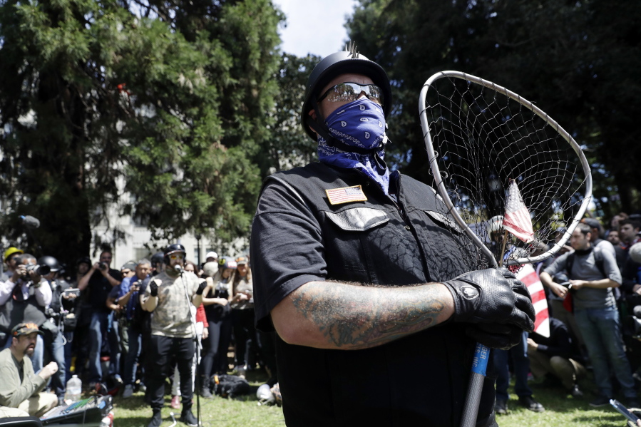 A demonstrator guards the speakers area during a rally for free speech in Berkeley, Calif., on April 27. Northern California police and civic leaders are hoping for calm, but bracing for violence this weekend when hundreds, possibly thousands, of demonstrators of all stripes flock to the San Francisco Bay Area for dueling political rallies.
