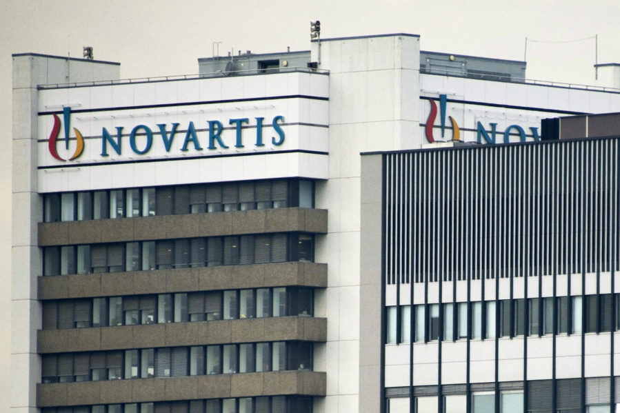 FILE - This Oct. 25, 2011 file photo shows the logo of Swiss pharmaceutical company Novartis AG on one of their buildings in Basel, Switzerland. According to results published Sunday, Aug. 27, 2017, for the first time, a drug has helped prevent heart attacks by curbing inflammation, a new and very different approach than lowering cholesterol, which has been the main focus for decades. Canakinumab’s maker, Novartis, sponsored the study.