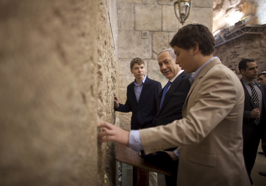 Israeli Prime Minister Benjamin Netanyahu, center, prays with his sons Yair, background, and Avner, right, in 2013 at the Western Wall in Jerusalem’s Old City.