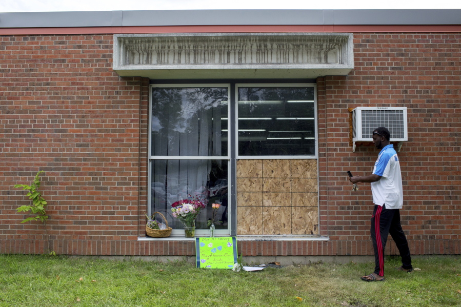 Abdul Mohamed photographs the damage outside of the Dar Al Farooq Islamic Center in Bloomington, Minn., on Sunday. An explosion damaged a room and shattered windows as worshippers prepared for morning prayers early Saturday.