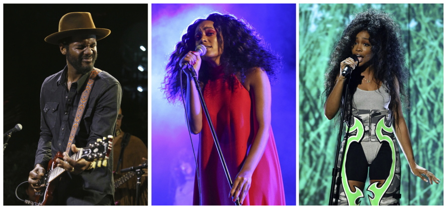 This combination photo shows, from left, Gary Clark Jr. at the South by Southwest Music Festival in Austin, Texas in March; Solange Knowles at the FYF Fest in Los Angeles in 2015; and SZA at the BET Awards in Los Angeles in June. They will perform at the Afropunk festival in Brooklyn’s Commodore Barry Park this weekend.