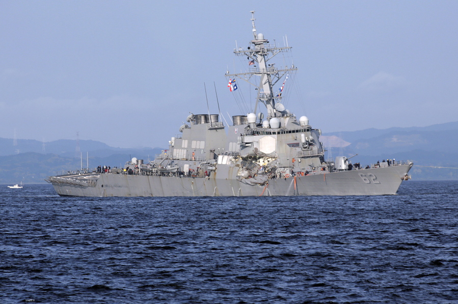 This June 17, 2017 file photo shows the damaged USS Fitzgerald near the U.S. Naval base in Yokosuka, southwest of Tokyo. The Navy says the commanding officer of a warship that lost seven sailors in a collision off the coast of Japan will be relieved of command, and nearly a dozen other sailors face punishment. Adm. William Moran, the No. 2 Navy officer, told reporters at the Pentagon on Thursday, Aug. 17, that the actions are to be taken shortly, although the Navy’s investigation into how and why the USS Fitzgerald collided with the container ship in June has not yet been completed.