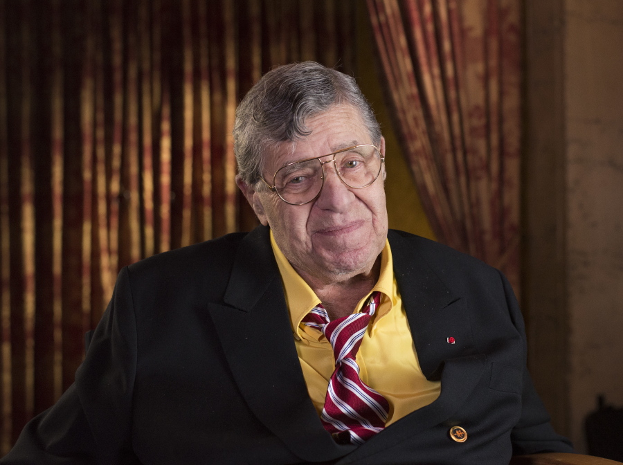 FILE - In this April 12, 2014, file photo, actor and comedian Jerry Lewis poses during an interview at TCL Chinese Theatre in Los Angeles. Lewis, the comedian and director whose fundraising telethons became as famous as his hit movies, has died. Lewis died Sunday, Aug. 20, 2017, according to his publicist. He was 91.