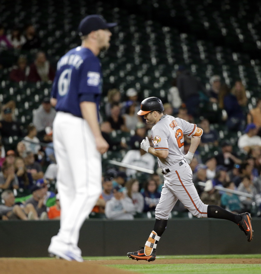 Baltimore Orioles’ Seth Smith rounds the bases on his two-run home run as Seattle Mariners relief pitcher Casey Lawrence waits on the mound in the fifth inning of a baseball game Monday, Aug. 14, 2017, in Seattle.
