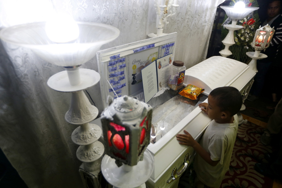 Jomari (only one name given), a friend of slain Kian Loyd delos Santos, refuses to leave the wake of his friend Friday in Caloocan city north of Manila, Philippines.