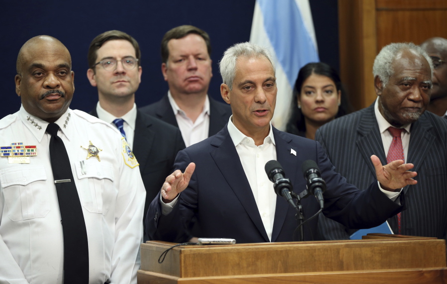 In this Aug. 6, 2017 photo, Chicago Mayor Rahm Emanuel, accompanied by Police Superintendent Eddie Johnson, left, and U.S. Rep. Danny Davis, right, announces a lawsuit against the Trump Justice Department over withholding funding for sanctuary cities at City Hall in Chicago. At least six so-called sanctuary cities are suing the U.S. government, over immigration-related policies to avoid losing millions in public safety dollars the Trump administration has threatened to withhold.