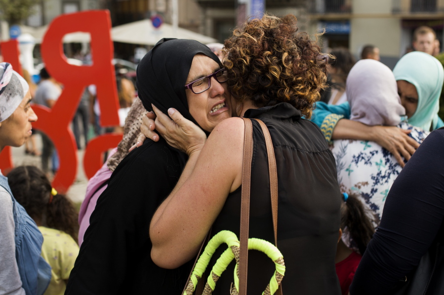 Families of young men believed responsible for the attacks in Barcelona and Cambrils gather along with members of the local Muslim community to denounce terrorism and show their grief in Ripoll, north of Barcelona, Spain, Saturday.