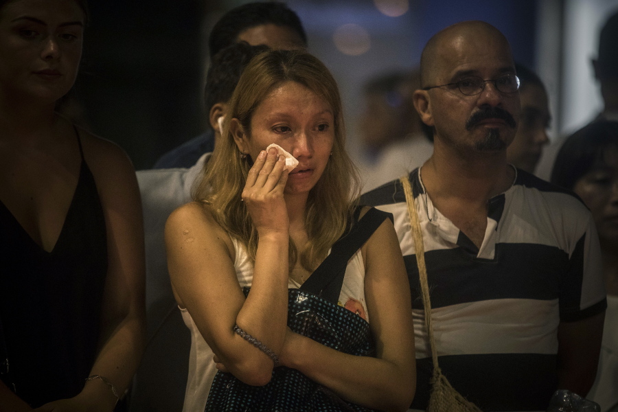 A woman cries early today in front of a memorial tribute to the victims of the terrorist attack in Barcelona, Spain.