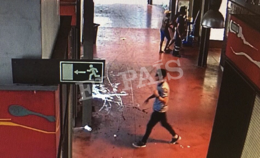 In this watermarked frame grab from CCTV released by the Spanish newspaper El Pais on Monday Aug. 21, 2017, a suspect. believed to be Younes Abouyaaqoub is is captured by a security camera walking through La Boqueria market seconds after a van crashed into pedestrians in Barcelona last August 17. Spanish newspaper El Pais published images Monday of what it says is Younes Abouyaaqoub supposedly making a getaway on foot after the Barcelona van attack. The three images show a slim man wearing sunglasses seemingly walking through what El Pais says is traditional La Boqueria market just off Las Ramblas.