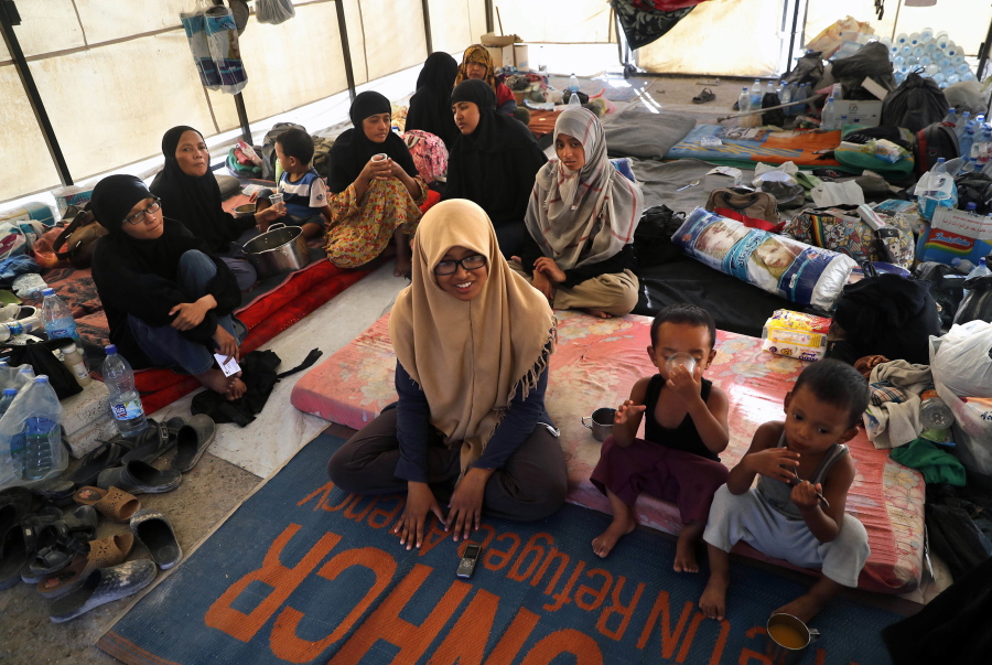 In this picture taken on Monday, July 24, 2017, an Indonesian family who escaped from the Islamic State group in Raqqa gather inside their tent at a refugee camp, in Ain Issa, Syria. Indonesia’s deputy foreign minister says the Jakarta family who joined the Islamic State group in Syria out of an apparently naive belief it would give them a better life is now in Iraq and in contact with the Indonesian government.