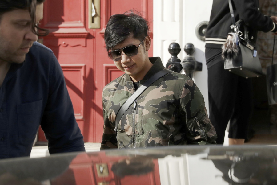 Vorayuth “Boss” Yoovidhya, whose grandfather co-founded energy drink company Red Bull, walks to get in a car as he leaves a house in London. Interpol on Monday, Aug. 28, 2017, issued an international request for the arrest of the billionaire heir to the Red Bull energy drink fortune, stepping up the hunt for the fugitive Thai playboy wanted in allegedly killing of a traffic policeman in a 2012 hit-and-run incident in Bangkok.