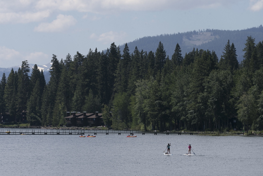 Paddle boarders ply the waters of Lake Tahoe near Tahoe City, Calif., on Aug. 8. Lake Tahoe’s known for summer and winter fun, but there’s a third side to Tahoe: fall, when crowds thin out, rates are cheaper and trees put on a show.