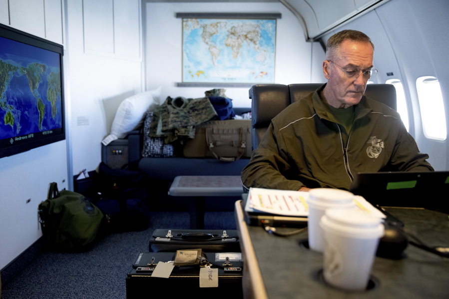 Joint Chiefs Chairman Gen. Joseph Dunford works in his private cabin aboard his plane Saturday while traveling to Andrews Air Force Base, Md.