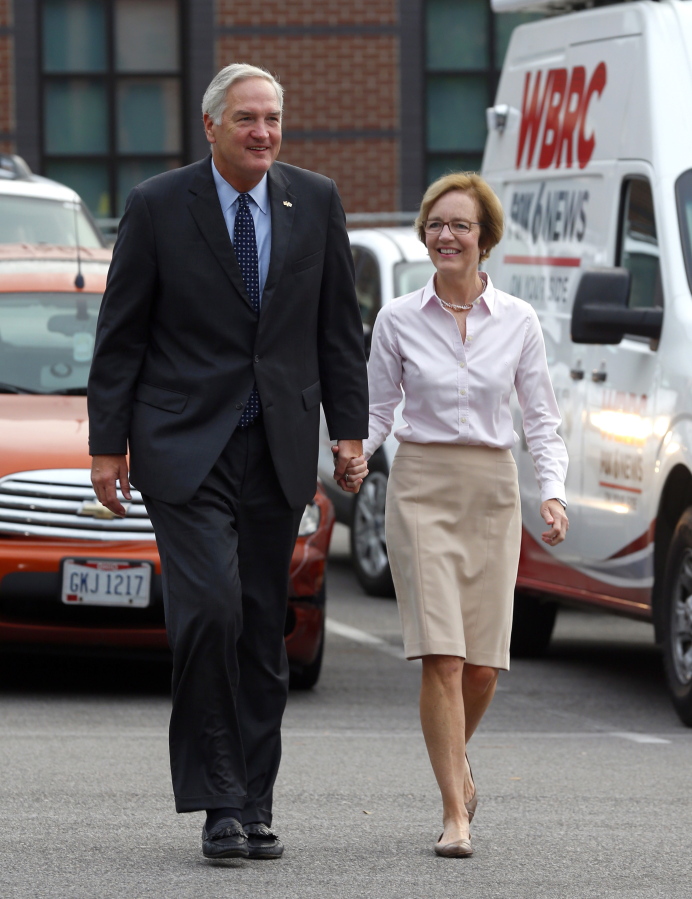 Senator Luther Strange walks in with his wife, Melissa, to cast their votes Tuesday in Homewood, Ala. Alabama voters are casting ballots Tuesday to select party nominees in the closely watched Senate race for the seat that belonged to Attorney General Jeff Sessions.