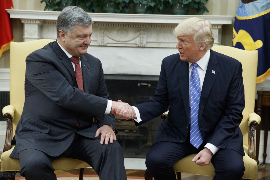 President Donald Trump shakes hands with Ukrainian President Petro Poroshenko during a meeting in the Oval Office of the White House in Washington on June 20.