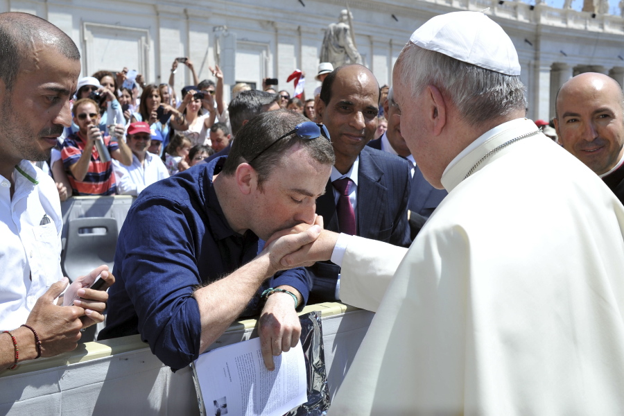 Irish psychotherapist Vincent Doyle kisses Pope Francis’ hand in 2014 during a general audience in St. Peter’s Square, at the Vatican. Doyle, who was fathered by a priest, started the online resource Coping International for children of priests and their mothers.