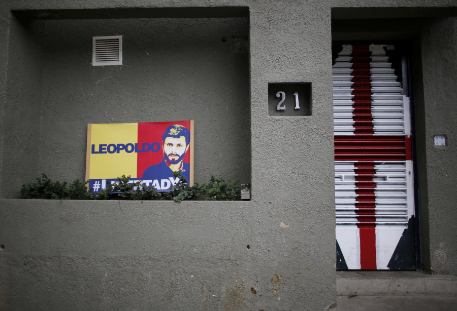 A banner with the image of opposition leader Leopoldo Lopez sits outside of his home in Caracas, Venezuela, on Tuesday. Allies of two Venezuelan opposition leaders say Lopez and Antonio Ledezma have been taken by authorities from the homes where they were under house arrest. Video posted on the Twitter account of Lopez’s wife early Tuesday, Aug. 1, shows a man being taken away from a Caracas home by state security agents.