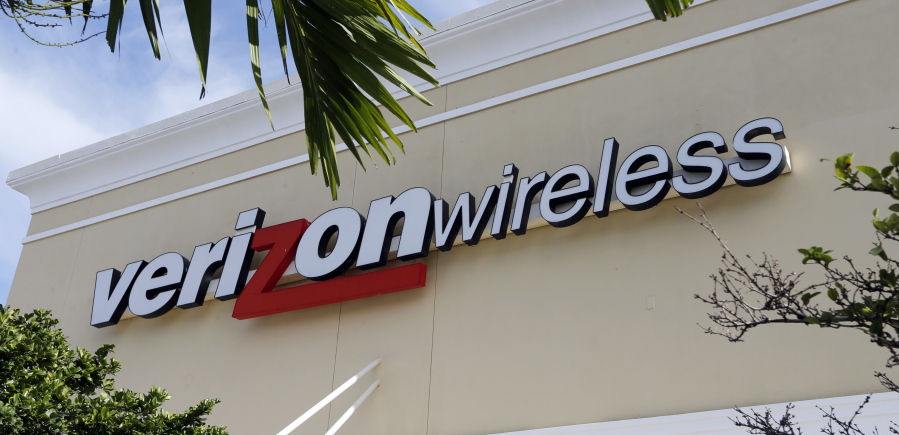 A Verizon wireless sign in Miami. Verizon is raising the price on its unlimited plan while introducing a slightly cheaper, more limited version of it as wireless carriers battle each other for customers.