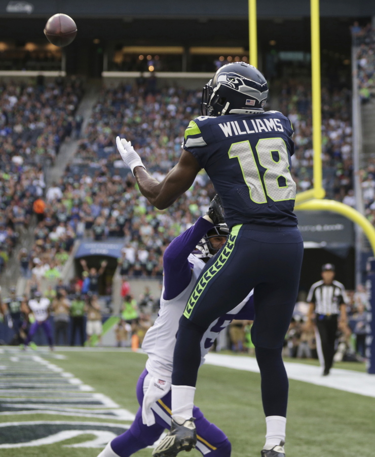 Seattle Seahawks wide receiver Kasen Williams (18) catches a pass above the defense of Minnesota Vikings cornerback Marcus Sherels for a touchdown during the first half of an NFL football preseason game, Friday, Aug. 18, 2017, in Seattle.